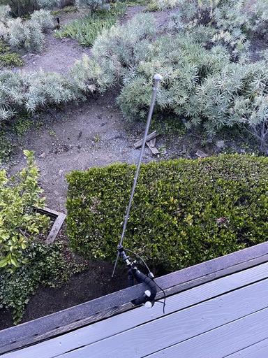 The dipole antenna attached to a railing.
